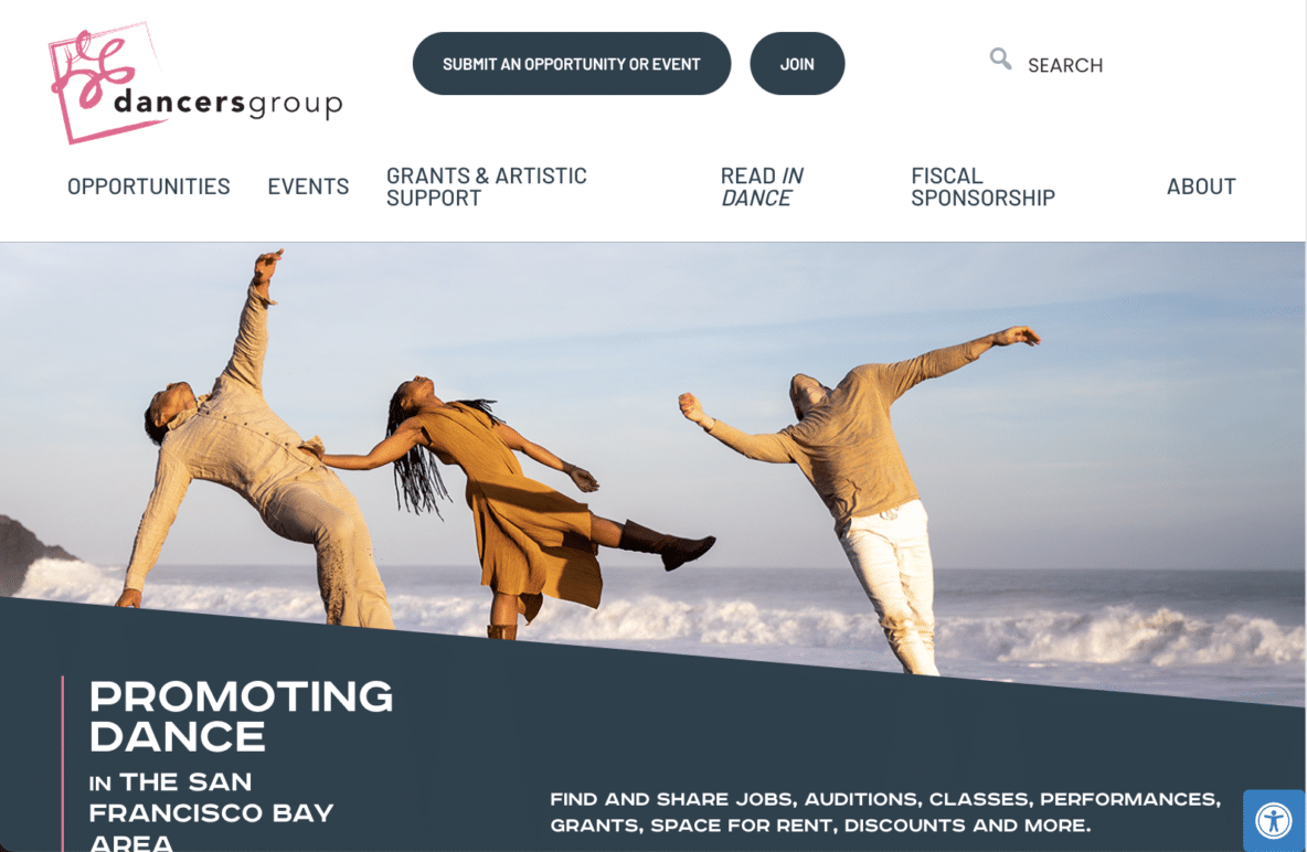 Three dancers pose on a beach, each extending an arm and leg in different directions. Waves crash in the background under a blue sky. The website banner shows the Dancers Group logo and navigation menu.