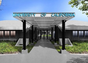 Covered walkway leading to a building entrance with a sign that reads University of California. The building has large windows and is surrounded by greenery under a clear blue sky.